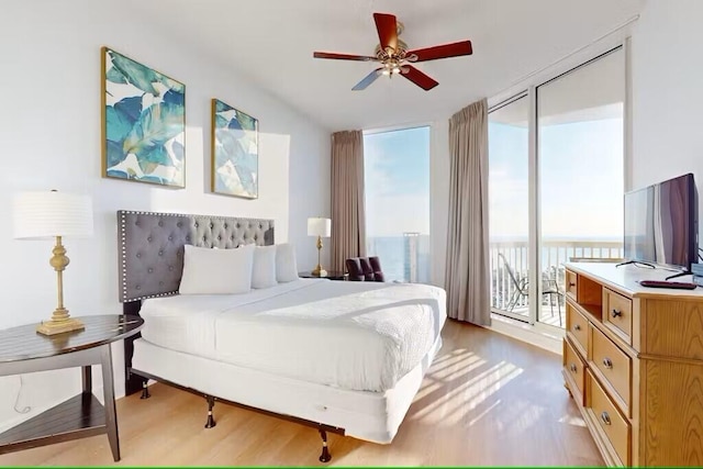 15100 Emerald Coast Pkwy Unit Ph4, Destin, FL 32541 - bedroom featuring wood finished floors, access to exterior, and a wall of windows