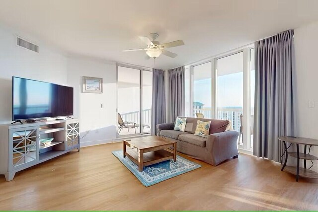 15100 Emerald Coast Pkwy Unit Ph4, Destin, FL 32541 - living room with ceiling fan, wood finished floors, and floor to ceiling windows