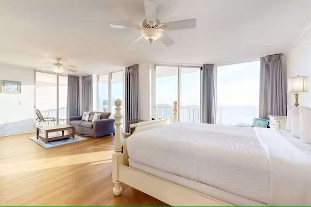 15100 Emerald Coast Pkwy Unit Ph4, Destin, FL 32541 - bedroom featuring light wood-style floors, a wall of windows, and ceiling fan