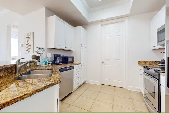 15100 Emerald Coast Pkwy Unit Ph4, Destin, FL 32541 - kitchen featuring appliances with stainless steel finishes, a sink, white cabinets, light tile patterned floors, and stone counters