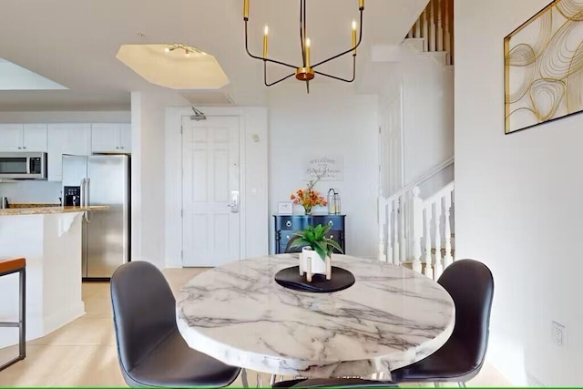 15100 Emerald Coast Pkwy Unit Ph4, Destin, FL 32541 - dining area with light tile patterned floors and a chandelier