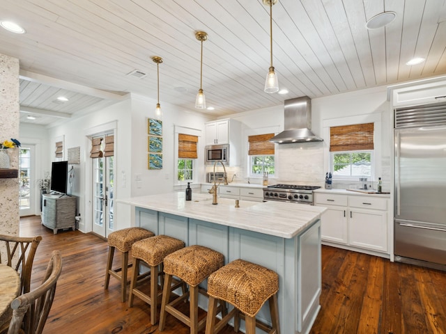 121 Red Cedar Way, Santa Rosa Beach, FL 32459 - kitchen featuring built in appliances, wall chimney range hood, wood ceiling, dark wood-style floors, and a breakfast bar area