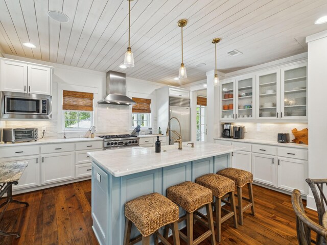 121 Red Cedar Way, Santa Rosa Beach, FL 32459 - kitchen featuring wall chimney range hood, built in appliances, wood ceiling, tasteful backsplash, and white cabinets