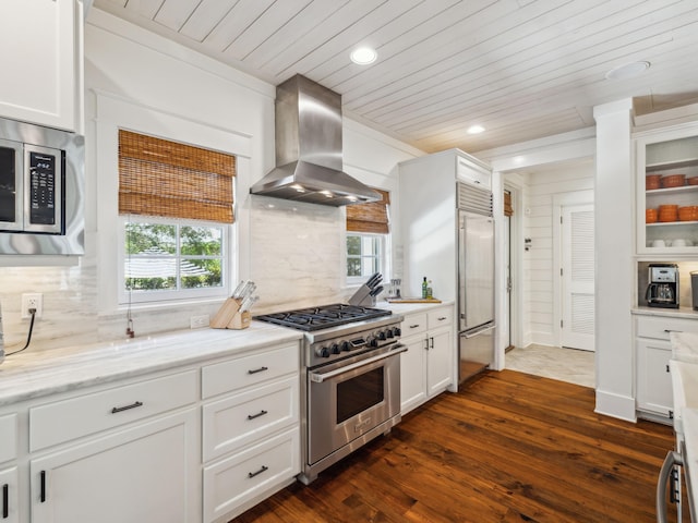 121 Red Cedar Way, Santa Rosa Beach, FL 32459 - kitchen with premium appliances, wall chimney range hood, wood ceiling, dark wood-style floors, and white cabinets