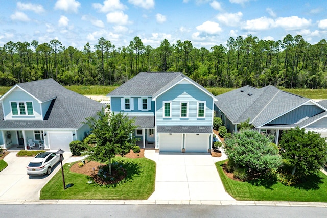 101 Windrow Way Lot 255, Watersound, FL 32461 - traditional-style home with driveway, a garage, covered porch, and a wooded view