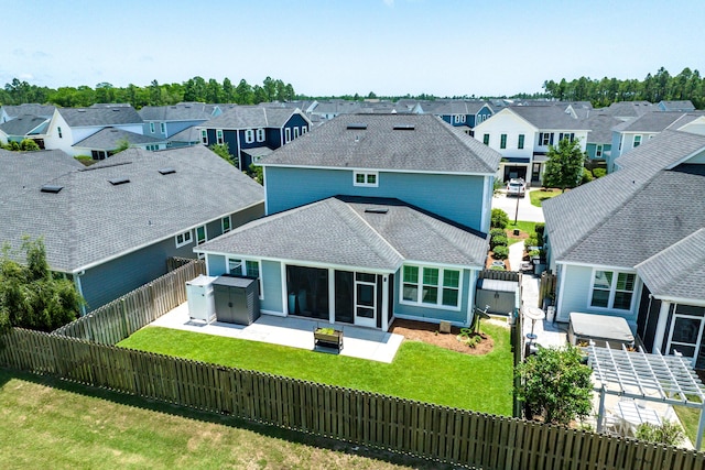101 Windrow Way Lot 255, Watersound, FL 32461 - rear view of house featuring a residential view, roof with shingles, a patio area, a sunroom, and a gate