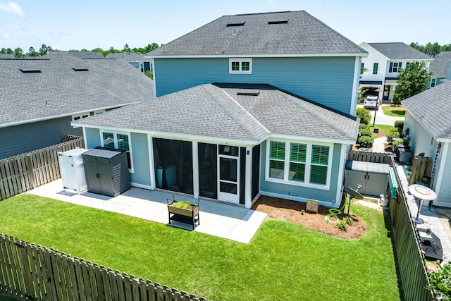 101 Windrow Way Lot 255, Watersound, FL 32461 - rear view of house with roof with shingles, a patio area, a sunroom, and a storage shed