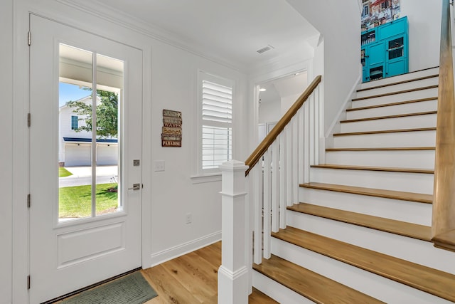 101 Windrow Way Lot 255, Watersound, FL 32461 - foyer entrance featuring plenty of natural light, light wood finished floors, stairs, baseboards, and ornamental molding
