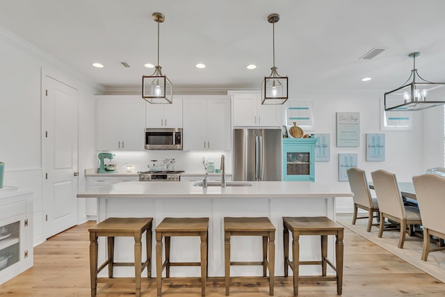 101 Windrow Way Lot 255, Watersound, FL 32461 - kitchen with stainless steel appliances, a sink, a kitchen bar, light countertops, and crown molding