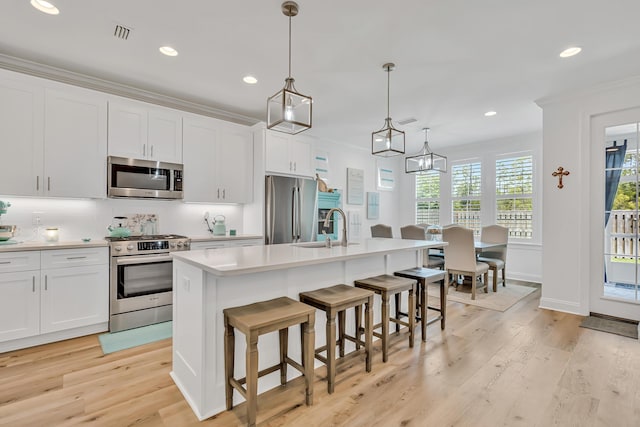 101 Windrow Way Lot 255, Watersound, FL 32461 - kitchen featuring stainless steel appliances, a sink, recessed lighting, light wood-type flooring, and a center island with sink