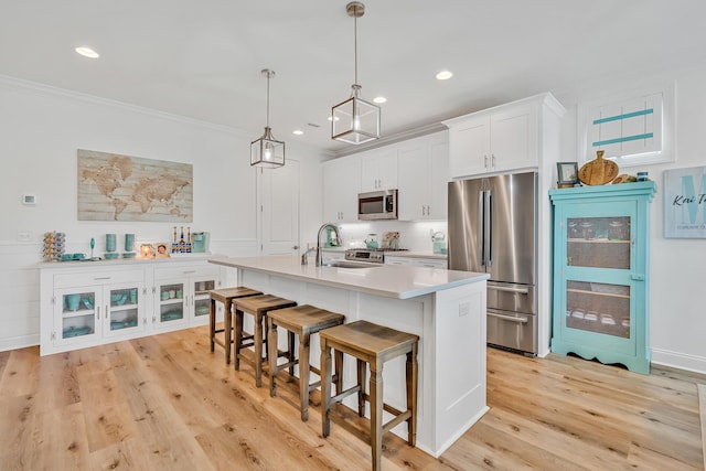 101 Windrow Way Lot 255, Watersound, FL 32461 - kitchen with stainless steel appliances, a kitchen bar, a center island with sink, white cabinets, and light countertops