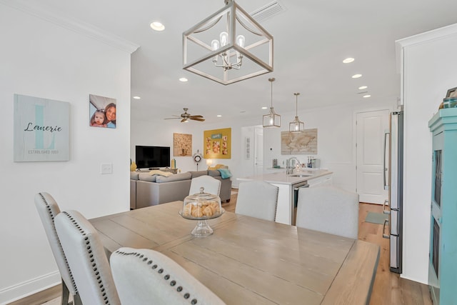 101 Windrow Way Lot 255, Watersound, FL 32461 - dining space with light wood-style floors, recessed lighting, a chandelier, ceiling fan, and ornamental molding