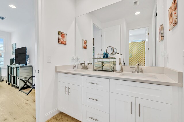 101 Windrow Way Lot 255, Watersound, FL 32461 - full bathroom featuring double vanity, baseboards, recessed lighting, wood finished floors, and a shower with shower curtain