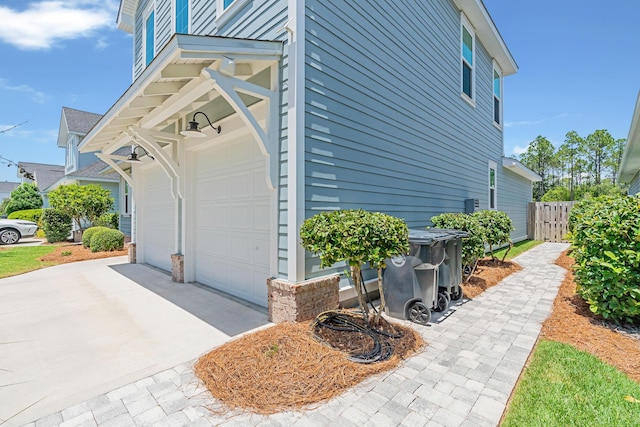 101 Windrow Way Lot 255, Watersound, FL 32461 - view of side of home with a garage, driveway, and fence