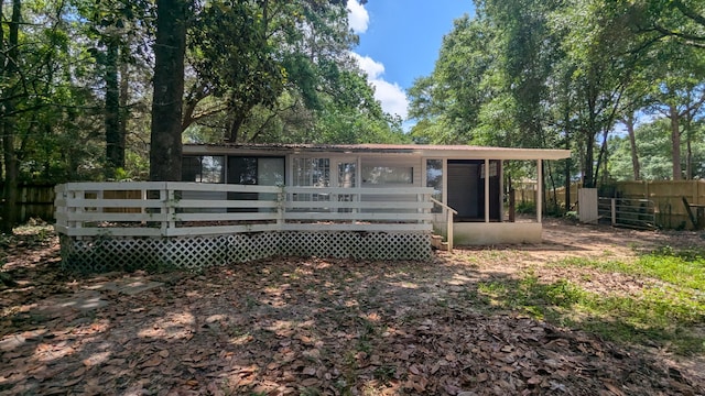back of house with fence and a deck