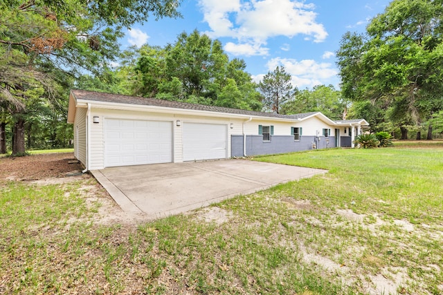 540 John King Rd, Crestview, FL 32539 - view of front of home with concrete driveway, an attached garage, a front yard, and view of wooded area