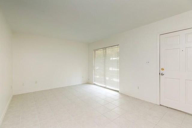 3871 Indian Trl Unit 2E, Destin, FL 32541 - spare room featuring baseboards and light tile patterned flooring