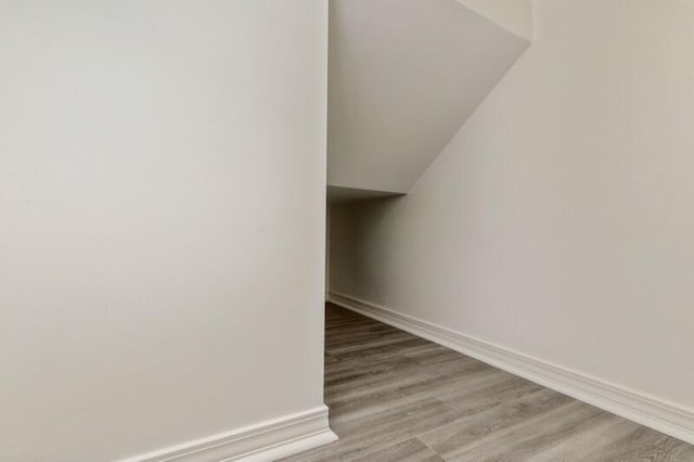 3871 Indian Trl Unit 2E, Destin, FL 32541 - stairs with wood finished floors, lofted ceiling, and baseboards