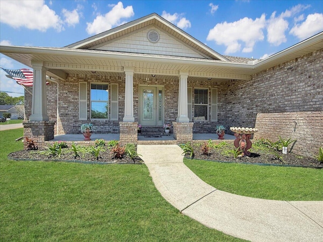 8296 Randall Dr, Navarre, FL 32566 - entrance to property featuring covered porch, a lawn, and brick siding