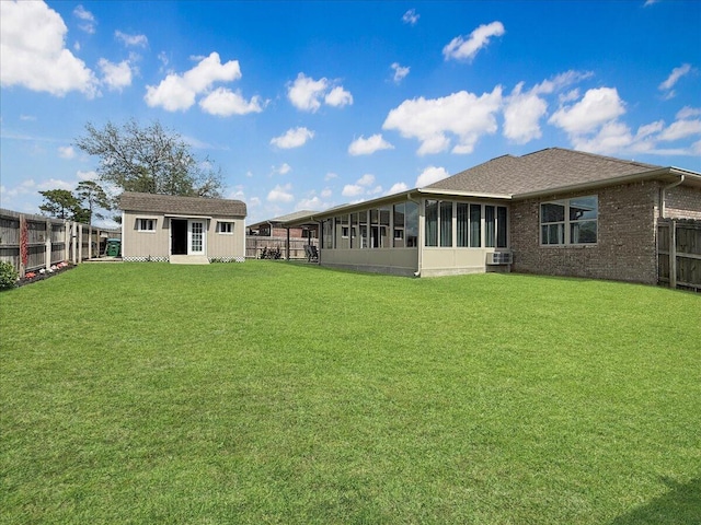 8296 Randall Dr, Navarre, FL 32566 - rear view of property featuring a sunroom, an outbuilding, and brick siding
