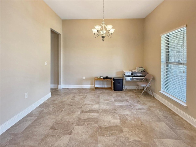 8296 Randall Dr, Navarre, FL 32566 - unfurnished dining area with a chandelier and baseboards