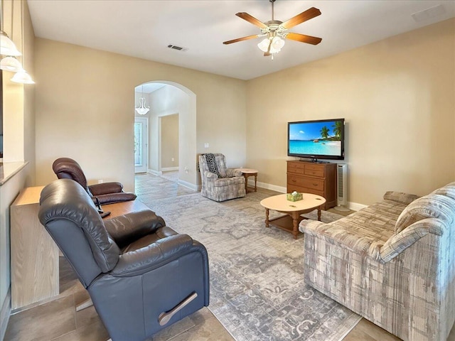 8296 Randall Dr, Navarre, FL 32566 - living area with arched walkways, a ceiling fan, and baseboards