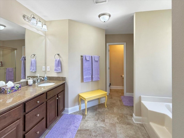 8296 Randall Dr, Navarre, FL 32566 - full bathroom featuring baseboards, a garden tub, and vanity