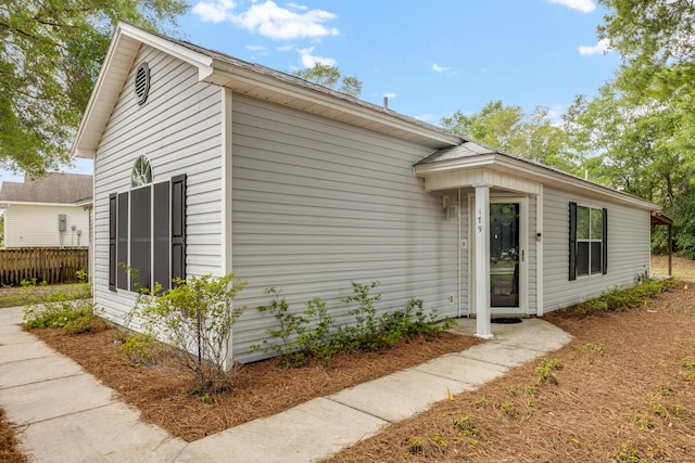 view of side of home with fence