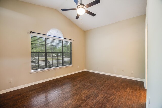 unfurnished room featuring dark wood-style flooring, a ceiling fan, vaulted ceiling, and baseboards