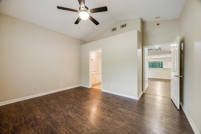 unfurnished bedroom with dark wood finished floors, high vaulted ceiling, baseboards, ensuite bathroom, and ceiling fan