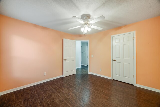 unfurnished bedroom featuring baseboards, dark wood-style floors, a ceiling fan, and a textured ceiling
