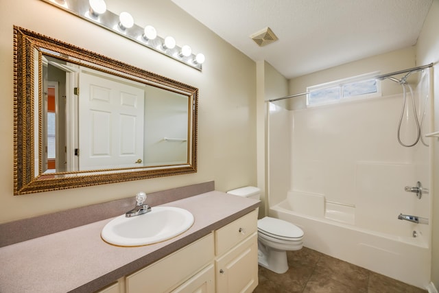 bathroom featuring toilet, tile patterned flooring, vanity, and  shower combination