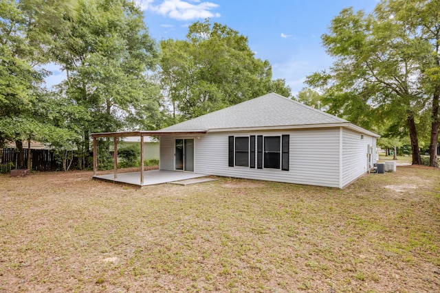 back of property featuring a patio area, a shingled roof, and central air condition unit