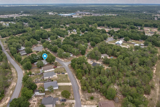 aerial overview of property's location with a heavily wooded area