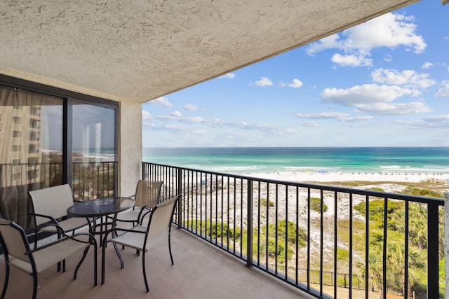 balcony with view of water and beach