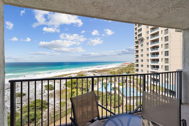 balcony with view of water and beach