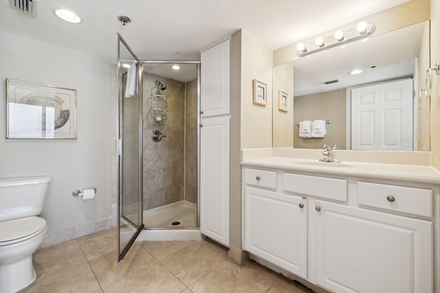 bathroom featuring baseboards, a stall shower, tile patterned floors, toilet, and vanity