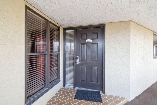 property entrance with stucco siding