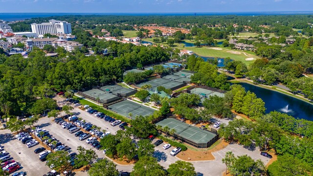 aerial view of property's location with a nearby body of water and a golf course