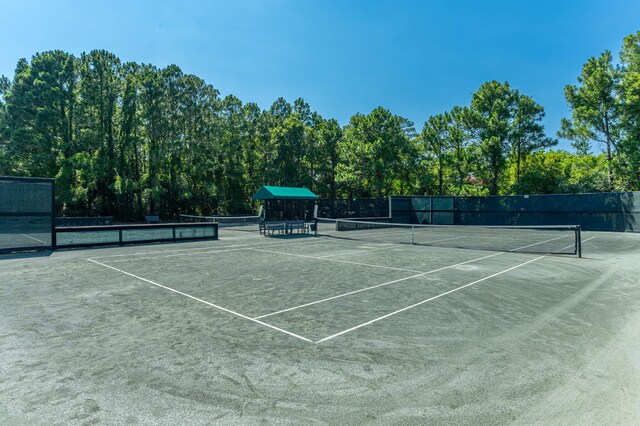 view of tennis court featuring fence