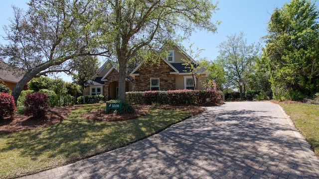 3208 Magnolia Islands Blvd, Panama City Beach, FL 32408 - craftsman house with stone siding, a front lawn, and driveway