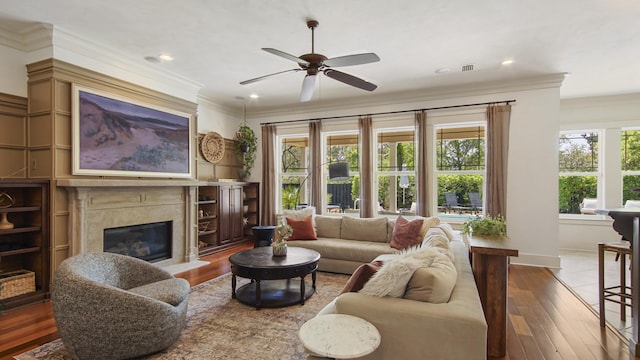 3208 Magnolia Islands Blvd, Panama City Beach, FL 32408 - living room featuring ornamental molding, a ceiling fan, hardwood / wood-style floors, a high end fireplace, and baseboards