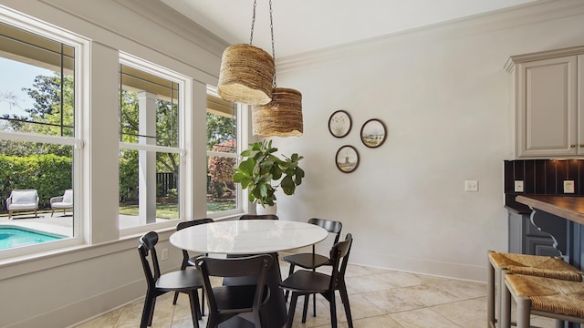 3208 Magnolia Islands Blvd, Panama City Beach, FL 32408 - dining space with baseboards, light tile patterned floors, and ornamental molding