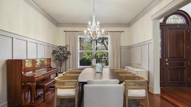 3208 Magnolia Islands Blvd, Panama City Beach, FL 32408 - dining space featuring a decorative wall, a chandelier, dark wood finished floors, ornamental molding, and a wainscoted wall