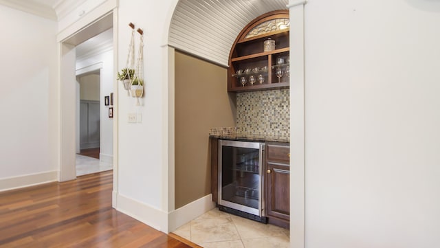 3208 Magnolia Islands Blvd, Panama City Beach, FL 32408 - indoor dry bar featuring wine cooler, tasteful backsplash, light wood finished floors, and baseboards