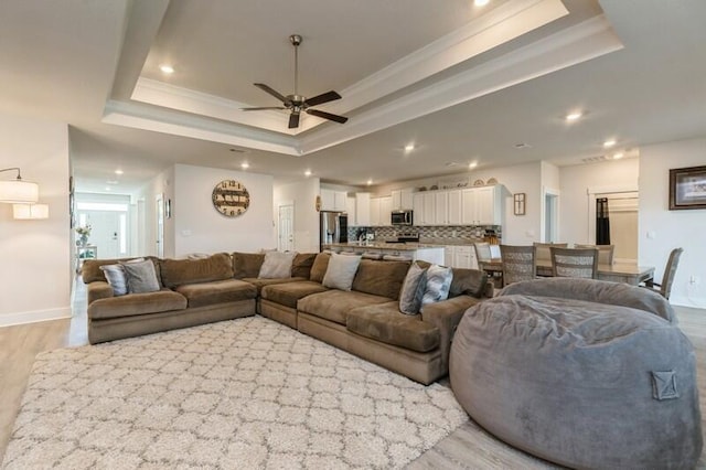 514 Mary Lou Way, Crestview, FL 32539 - living area featuring a raised ceiling, a ceiling fan, light wood-style floors, recessed lighting, and ornamental molding