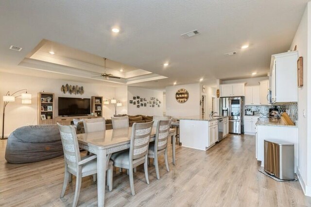 514 Mary Lou Way, Crestview, FL 32539 - dining space with ceiling fan, light wood-style flooring, a raised ceiling, and recessed lighting