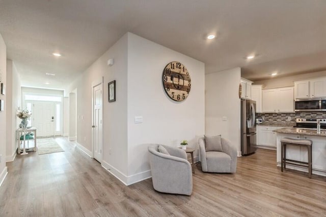 514 Mary Lou Way, Crestview, FL 32539 - kitchen featuring stainless steel appliances, light wood-style floors, tasteful backsplash, white cabinets, and recessed lighting