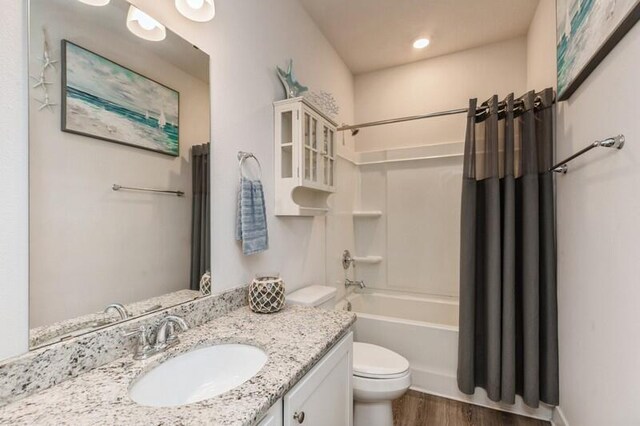 514 Mary Lou Way, Crestview, FL 32539 - full bathroom with toilet, vanity, wood finished floors, and shower / bathtub combination with curtain