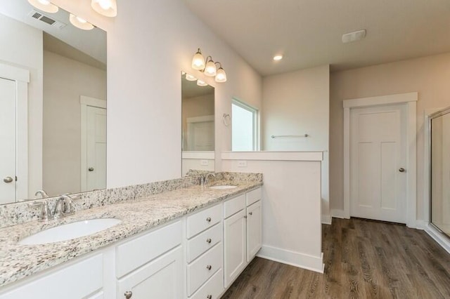 514 Mary Lou Way, Crestview, FL 32539 - full bath featuring wood finished floors, double vanity, baseboards, and a shower with shower door